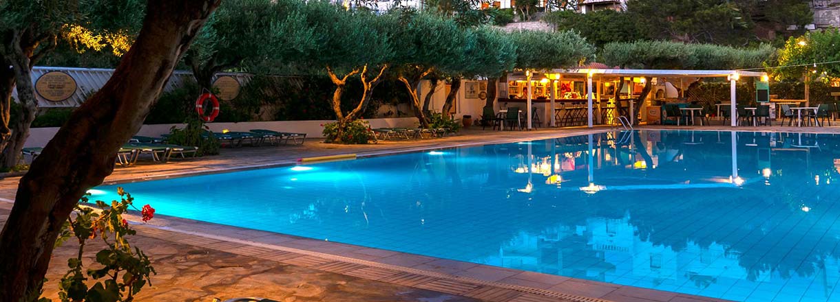 Heraklion Airport transfer to Villea Village Makry Gialos pool area at night